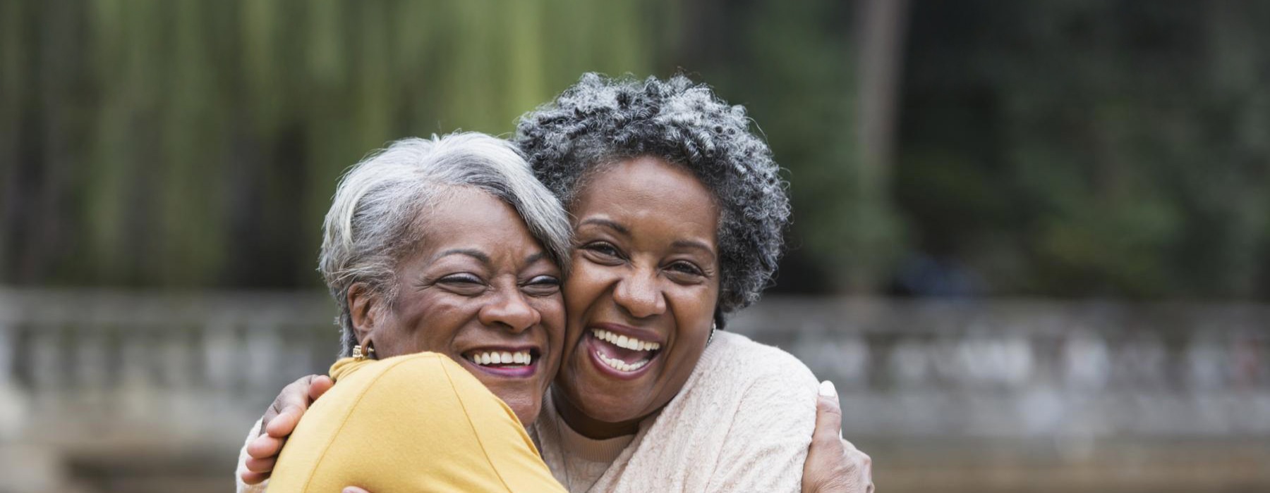 Friends hugging and laughing