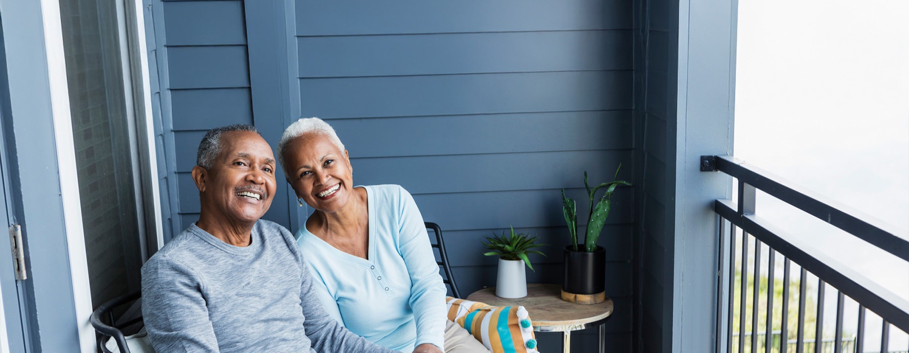 a couple relaxing on a balcony