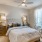 Model bedroom at our apartments for rent in Magnolia, featuring carpeted flooring and window with blinds.