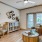 Model living room at our apartments for rent in Magnolia, featuring wood grain floor paneling and windows with blinds.