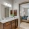 Model bathroom at our apartments in Magnolia, TX, featuring granite patterned countertops and a view of the bedroom.